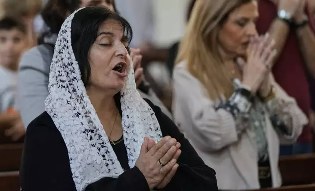 Christian worshippers take part in Sunday Mass at the Armenian Patriarchate in Antelias, north of Beirut, Lebanon, Sunday, Nov. 23, 2025. (AP Photo/Bilal Hussein)