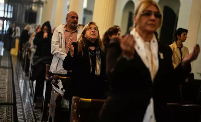 Armenian worshippers pray during Sunday Mass at the Surp Asdvadzadzin Patriarchal Church in Istanbul, Turkey, Sunday, Nov. 23, 2025, ahead of the visit of Pope Leo XIV to Turkey. (AP Photo/Khalil Hamra)
