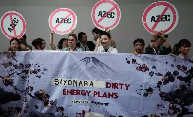 Activists protest Japan's financing of coal and natural gas projects during the COP30 U.N. Climate Summit, Friday, Nov. 14, 2025, in Belem, Brazil. (AP Photo/Fernando Llano)
