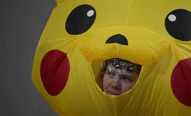 An activist, in a Pikachu costume, protests Japan's financing of coal and natural gas projects during the COP30 U.N. Climate Summit, Friday, Nov. 14, 2025, in Belem, Brazil. (AP Photo/Fernando Llano)
