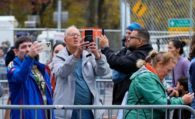 People take photos of Buzz Lightyear balloon during the preparations for the 99th Macy's Thanksgiving Day Parade Wednesday, Nov. 26, 2025, in New York. (AP Photo/Frank Franklin II)