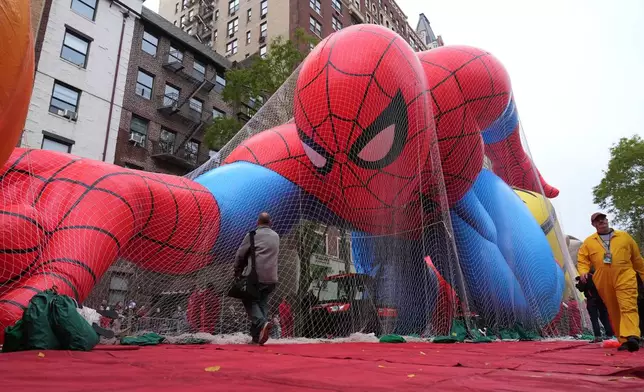 Volunteers pass a Spider-Man balloon during preparations for the 99th Macy's Thanksgiving Day Parade Wednesday, Nov. 26, 2025, in New York. (AP Photo/Frank Franklin II)