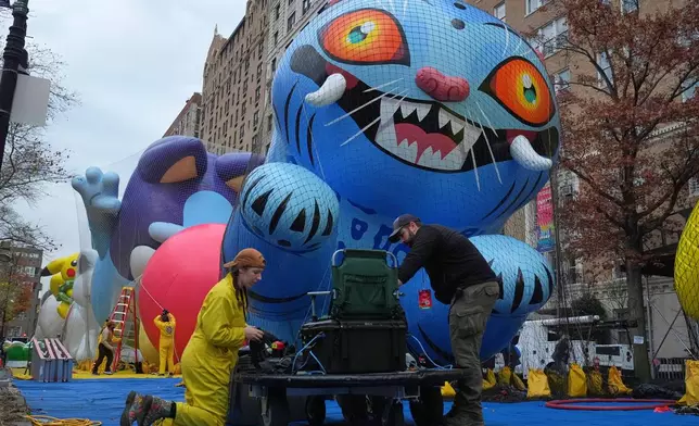 Volunteers work during the balloon inflation for the 99th Macy's Thanksgiving Day Parade Wednesday, Nov. 26, 2025, in New York. (AP Photo/Frank Franklin II)