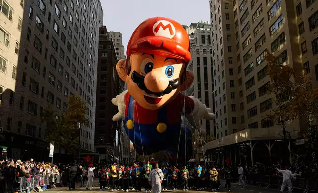 The Mario balloon floats down Sixth Avenue during the Macy's Thanksgiving Day Parade, Thursday, Nov. 27, 2025, in New York. (AP Photo/Eduardo Munoz Alvarez)