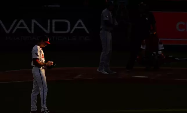 FILE - Los Angeles Angels starting pitcher Kyle Hendricks gets set to pitch to Texas Rangers' Jonah Heim during the second inning of a baseball game against the Texas Rangers, July 9, 2025 in Anaheim, Calif. (AP Photo/Mark J. Terrill, File)