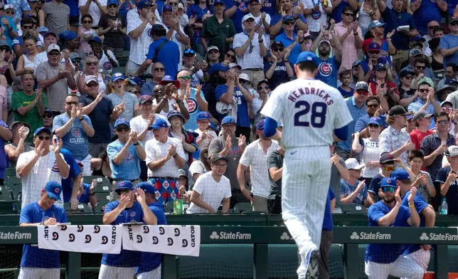 FILE - Chicago Cubs fans cheer Chicago Cubs pitcher Kyle Hendricks as he leaves during the sixth inning of a baseball game against the San Francisco Giants in Chicago, June 19, 2024. (AP Photo/Nam Y. Huh, File)