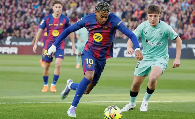 Barcelona's Lamine Yamal in action in front of Athletic Bilbao's Oihan Sancet during a La Liga soccer match between Barcelona and Athletic in Barcelona, Spain, Saturday, Nov. 22, 2025. AP Photo/Joan Monfort)