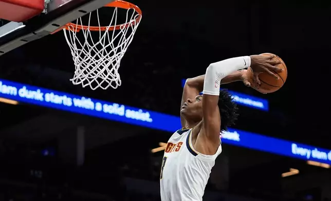 Denver Nuggets guard Peyton Watson (8) goes up for a dunk during the second half of an NBA basketball game against the Minnesota Timberwolves, Saturday, Nov. 15, 2025, in Minneapolis. (AP Photo/Abbie Parr)
