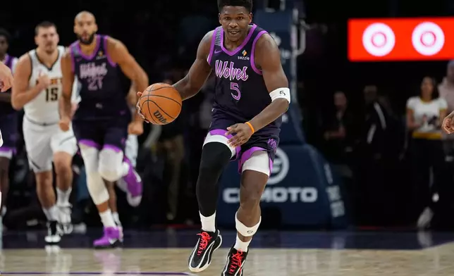 Minnesota Timberwolves guard Anthony Edwards (5) dribbles down the court during the first half of an NBA basketball game against the Denver Nuggets, Saturday, Nov. 15, 2025, in Minneapolis. (AP Photo/Abbie Parr)