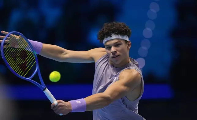 United States' Ben Shelton returns the ball to Germany's Alexander Zverev during their singles tennis match of the ATP World Tour Finals, in Turin, Italy, Sunday, Nov. 9, 2025. (AP Photo/Antonio Calanni)