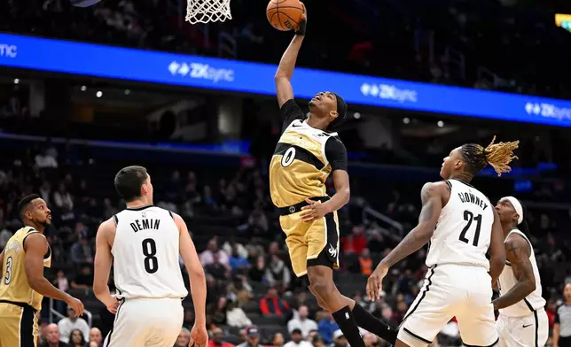 Washington Wizards guard Bilal Coulibaly (0) rises for a shot during the first half of an NBA basketball game against the Brooklyn Nets, Sunday, Nov. 16, 2025, in Washington. (AP Photo/John McDonnell)