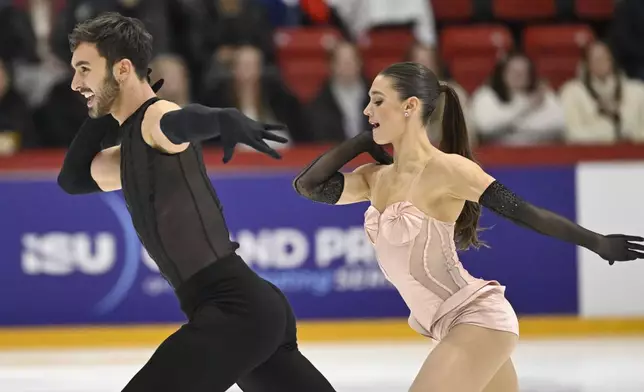 Laurence Fournier Beaudry and Guillaume Cizeron of France perform in Ice Dance Rhythm Dance during the figure skating ISU Grand Prix competition in Helsinki, Finland, Friday Nov. 21, 2025. (Heikki Saukkomaa/Lehtikuva via AP)