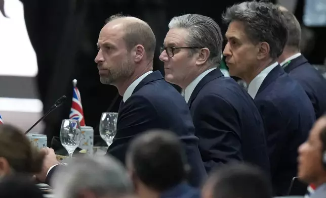 Britain's Prince William, left, and Britain's Prime Minister Keir Starmer, center, attend a plenary session at the COP30 U.N. Climate Summit, in Belem, Brazil, Thursday, Nov. 6, 2025. (AP Photo/Fernando Llano)