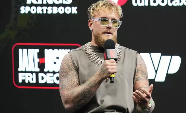 Jake Paul speaks during a news conference with Anthony Joshua promoting their upcoming heavyweight boxing match, Friday, Nov. 21, 2025, in Miami. (AP Photo/Lynne Sladky)