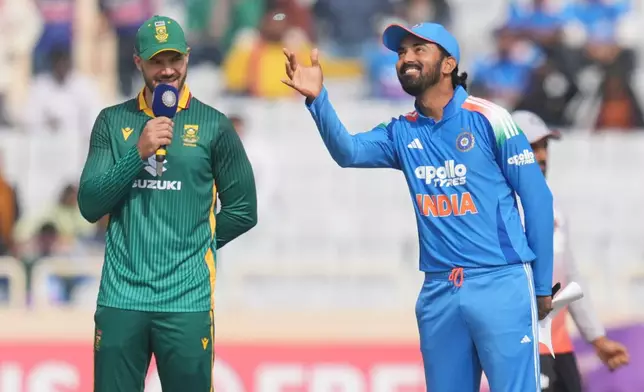 India's captain KL Rahul, right, flips coin for the toss as South Africa's captain Aiden Markram looks on during the first One Day International match between India and South Africa in Ranchi, India, Sunday, Nov. 30, 2025. (AP Photo/Rafiq Maqbool)