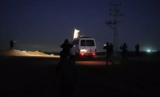 Red Cross convoy carrying the remains of a person believed to be a deceased hostage handed over by Gaza militants makes its way toward the border crossing with Israel, to be transferred to Israeli authorities, in Deir al-Balah, central Gaza Strip, Tuesday, Nov. 25, 2025. (AP Photo/Abdel Kareem Hana)