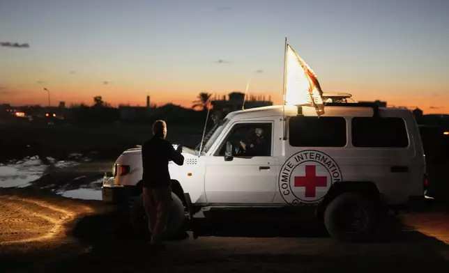 Red Cross convoy carrying the remains of a person believed to be a deceased hostage handed over by Gaza militants makes its way toward the border crossing with Israel, to be transferred to Israeli authorities, in Deir al-Balah, central Gaza Strip, Tuesday, Nov. 25, 2025. (AP Photo/Abdel Kareem Hana)