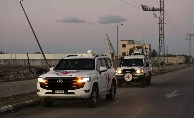Red Cross convoy carrying the remains of a person believed to be a deceased hostage handed over by Gaza militants makes its way toward the border crossing with Israel, to be transferred to Israeli authorities, in Deir al-Balah, central Gaza Strip, Tuesday, Nov. 25, 2025. (AP Photo/Abdel Kareem Hana)