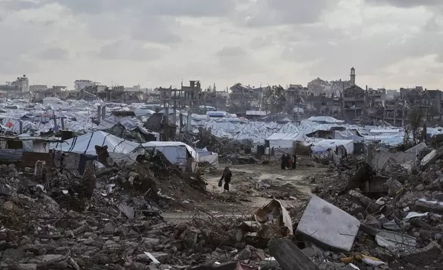 A tent camp for displaced Palestinians stand amid the destruction left by Israeli strikes north of Gaza City Tuesday, Nov. 25, 2025. (AP Photo/Jehad Alshrafi)