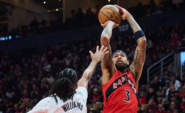 Toronto Raptors' Brandon Ingram (3) lines up a three-point shot past Brooklyn Nets' Ziaire Williams (1) during first half NBA basketball action in Toronto, on Sunday, Nov. 23, 2025. (Sammy Kogan/The Canadian Press via AP)
