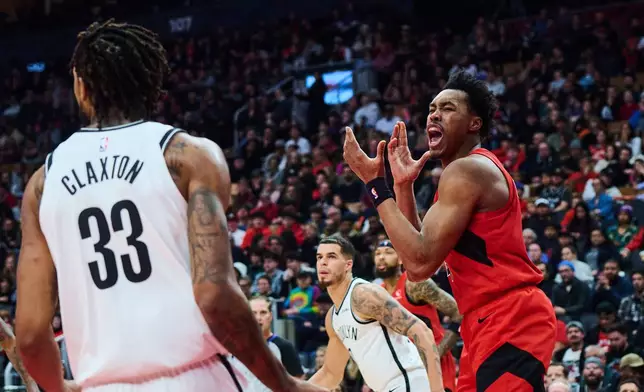 Toronto Raptors' Scottie Barnes (4) reacts after a block from Brooklyn Nets' Nic Claxton (33) during first half NBA basketball action in Toronto, on Sunday, Nov. 23, 2025. (Sammy Kogan/The Canadian Press via AP)