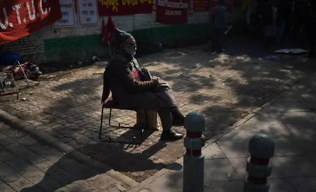An elderly member of a trade unions waits for the start of a protest against the government's rollout of new labor codes in New Delhi, India, Wednesday, Nov. 26, 2025. (AP Photo/Manish Swarup)