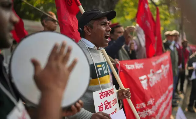 Members of various Indian trade unions shout slogans during a protest against the government's rollout of new labor codes in New Delhi, India, Wednesday, Nov. 26, 2025. (AP Photo/Manish Swarup)