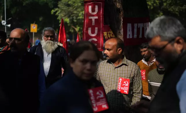 Members of various Indian trade unions listen to a speech of their leader during a protest against the government's rollout of new labor codes in New Delhi, India, Wednesday, Nov. 26, 2025. (AP Photo/Manish Swarup)