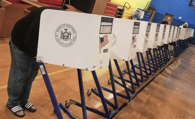 A voter completes their ballot at a voting site, in New York, Tuesday, Nov. 4, 2025. (AP Photo/Richard Drew)