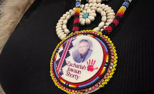 Vangie Randall-Shorty wears a button in memory of her son Zachariah Shorty in Bernalillo, New Mexico, Nov. 24, 2025. (AP Photo/Susan Montoya Bryan)