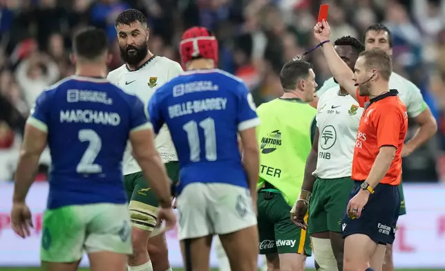 South Africa's Lood de Jager, second left, gets a red card from referee Angus Gardner during the rugby union Nations Series match between France and South Africa in Saint-Denis, outside Paris, Saturday, Nov. 8, 2025 . (AP Photo/Michel Euler)