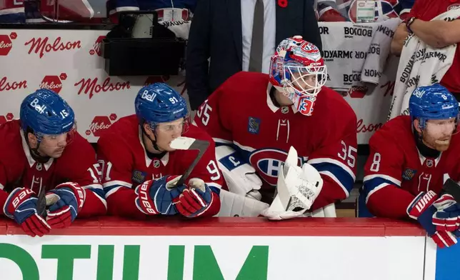 Montreal Canadiens goaltender Sam Montembeault watches action from the bench during the third period of an NHL hockey game in Montreal, Tuesday, Nov. 11, 2025. (Christinne Muschi/The Canadian Press via AP)