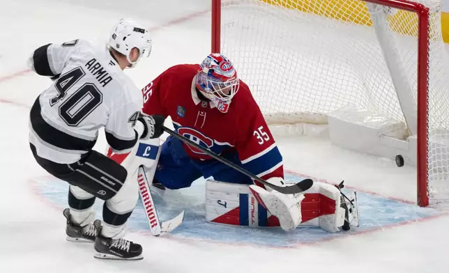Los Angeles Kings' Joel Armia (40) scores on Montreal Canadiens goaltender Sam Montembeault (35) during third period NHL hockey action in Montreal on Tuesday, Nov. 11, 2025. (Christinne Muschi/The Canadian Press via AP)