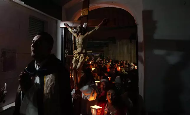People take part in a Day of the Dead procession in Quito, Ecuador, Saturday, Nov. 1, 2025. (AP Photo/Dolores Ochoa)