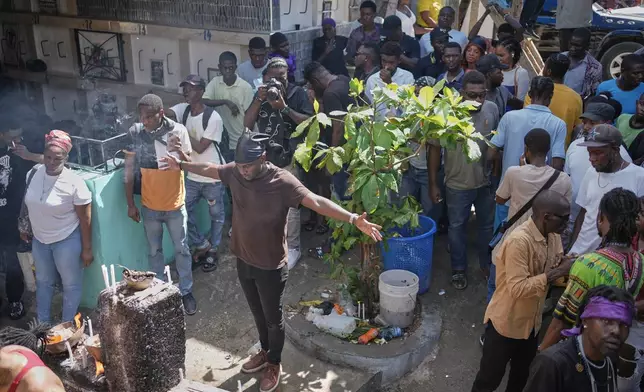Devotees take part in the annual Fete Gede festival that celebrates Day of the Dead, honoring the Haitian spirits Baron Samedi and Gede, at a cemetery in Port-au-Prince, Haiti, Saturday, Nov. 1, 2025. (AP Photo/Odelyn Joseph)