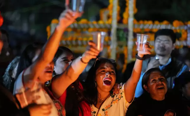 Families gather to keep company with their dearly departed celebrating the Day of the Dead at the cemetery of Tzintzuntzan, Michoacan state, Mexico, Friday, Oct. 31, 2025. (AP Photo/Eduardo Verdugo)