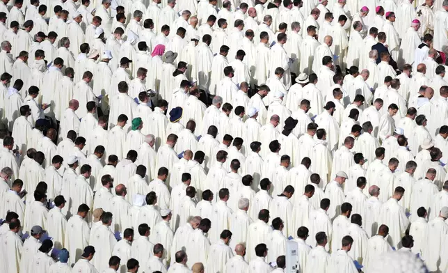 Priests attend a Mass with Pope Leo XIV and the Jubilee of the Educational World on the Solemnity of All Saints, in St. Peter's Square, at the Vatican, Saturday, Nov. 1, 2025, during which he will proclaim St. John Henry Newman a Doctor of the Church. (AP Photo/Andrew Medichini)
