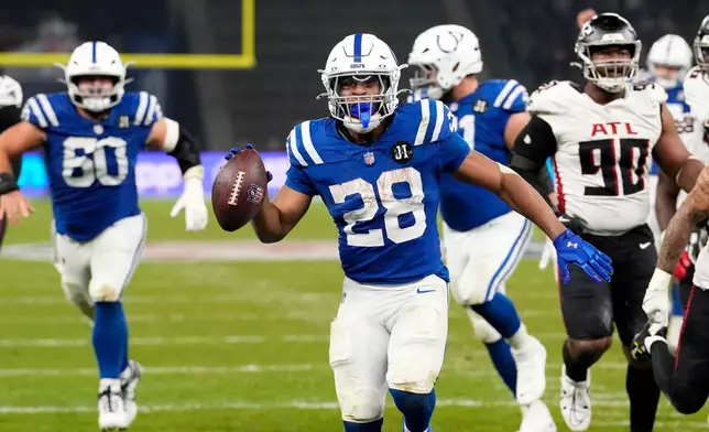 Indianapolis Colts running back Jonathan Taylor (28) scores a touchdown during overtime in an NFL football game against the Atlanta Falcons, Sunday, Nov. 9, 2025, in Berlin, Germany. (AP Photo/Martin Meissner)