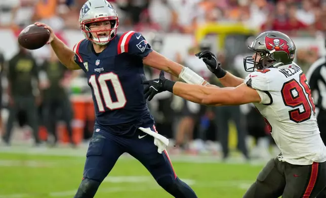 Tampa Bay Buccaneers linebacker Anthony Nelson (98) pressures New England Patriots quarterback Drake Maye (10) during the second half of an NFL football game Sunday, Nov. 9, 2025, in Tampa, Fla. (AP Photo/Chris O'Meara)