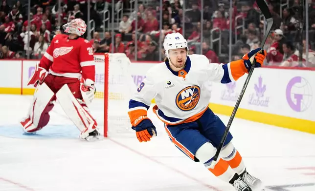 New York Islanders right wing Max Shabanov, right, reacts after scoring against Detroit Red Wings goaltender John Gibson, left, during the third period of an NHL hockey game Thursday, Nov. 20, 2025, in Detroit. (AP Photo/Ryan Sun)