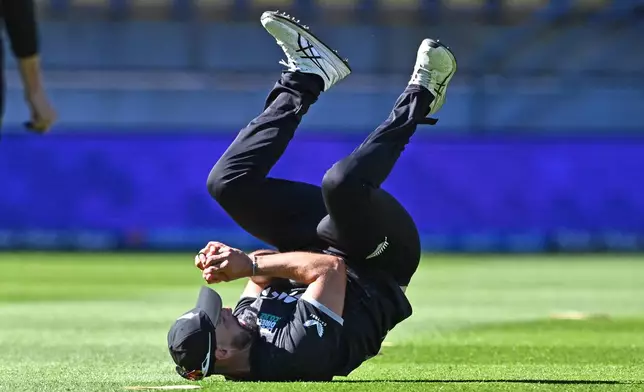 Daryl Mitchell of New Zealand takes a catch to dismiss Brydon Carse of England during the One Day International cricket match between New Zealand and England in Wellington, New Zealand, Saturday, Nov. 1, 2025. (Kerry Marshall/Photosport via AP)