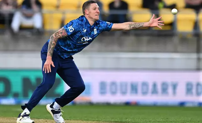 Brydon Carse of England attempts to field the ball during the One Day International cricket match between New Zealand and England in Wellington, New Zealand, Saturday, Nov. 1, 2025. (Kerry Marshall/Photosport via AP)