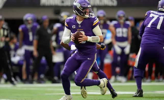 Minnesota Vikings quarterback J.J. McCarthy (9) looks to pass during the first half of an NFL football game against the Chicago Bears, Sunday, Nov. 16, 2025, in Minneapolis. (AP Photo/Abbie Parr)