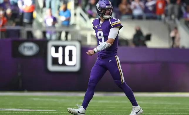 Minnesota Vikings quarterback J.J. McCarthy (9) reacts after throwing an interception during the first half of an NFL football game against the Chicago Bears, Sunday, Nov. 16, 2025, in Minneapolis. (AP Photo/Matt Krohn)