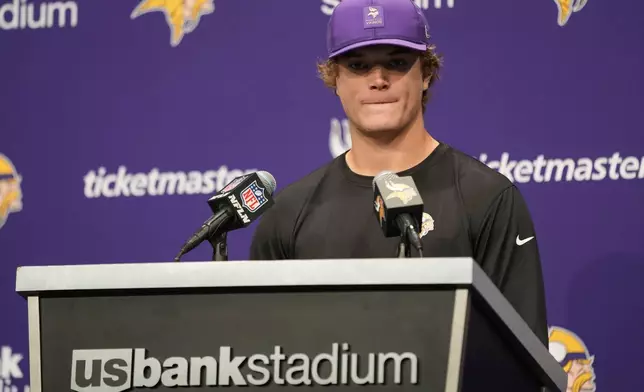 Minnesota Vikings quarterback J.J. McCarthy (9) speaks after his team's loss to the Chicago Bears in an NFL football game, Sunday, Nov. 16, 2025, in Minneapolis. (AP Photo/Abbie Parr)