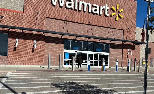 FILE - A shopper heads into a Walmart store Thursday, Oct. 16, 2025, in Englewood, Colo. (AP Photo/David Zalubowski, File)