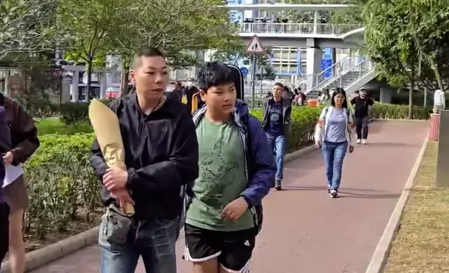 Mr. Chow and his teenage son, Photo by Bastille Post