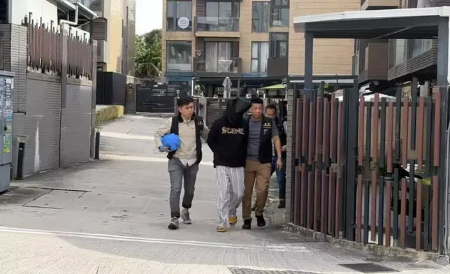 The police earlier escorted the suspect back to his residence in Yuen Long for evidence collection. Photo by Bastille Post