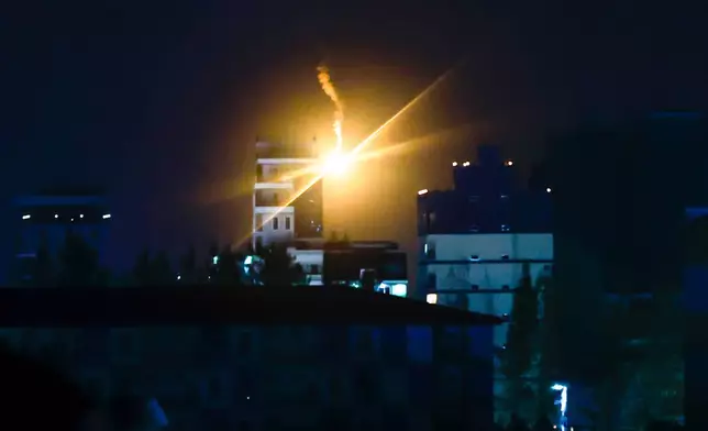 Illumination flares fired by Thai military forces shine in Poipet, Cambodia, as seen from Sa Kaeo, Thailand, on Friday, Dec. 26, 2025, following clashes between Thai and Cambodian soldiers. (AP Photo/Wason Wanichakorn)