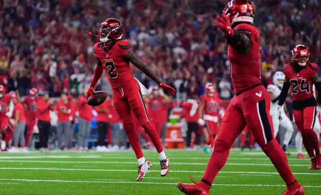 Houston Texans safety Calen Bullock (2) celebrates after intercepting a Buffalo Bills' Josh Allen pass in the second half of an NFL football game Thursday, Nov. 20, 2025, in Houston. (AP Photo/Ashley Landis)